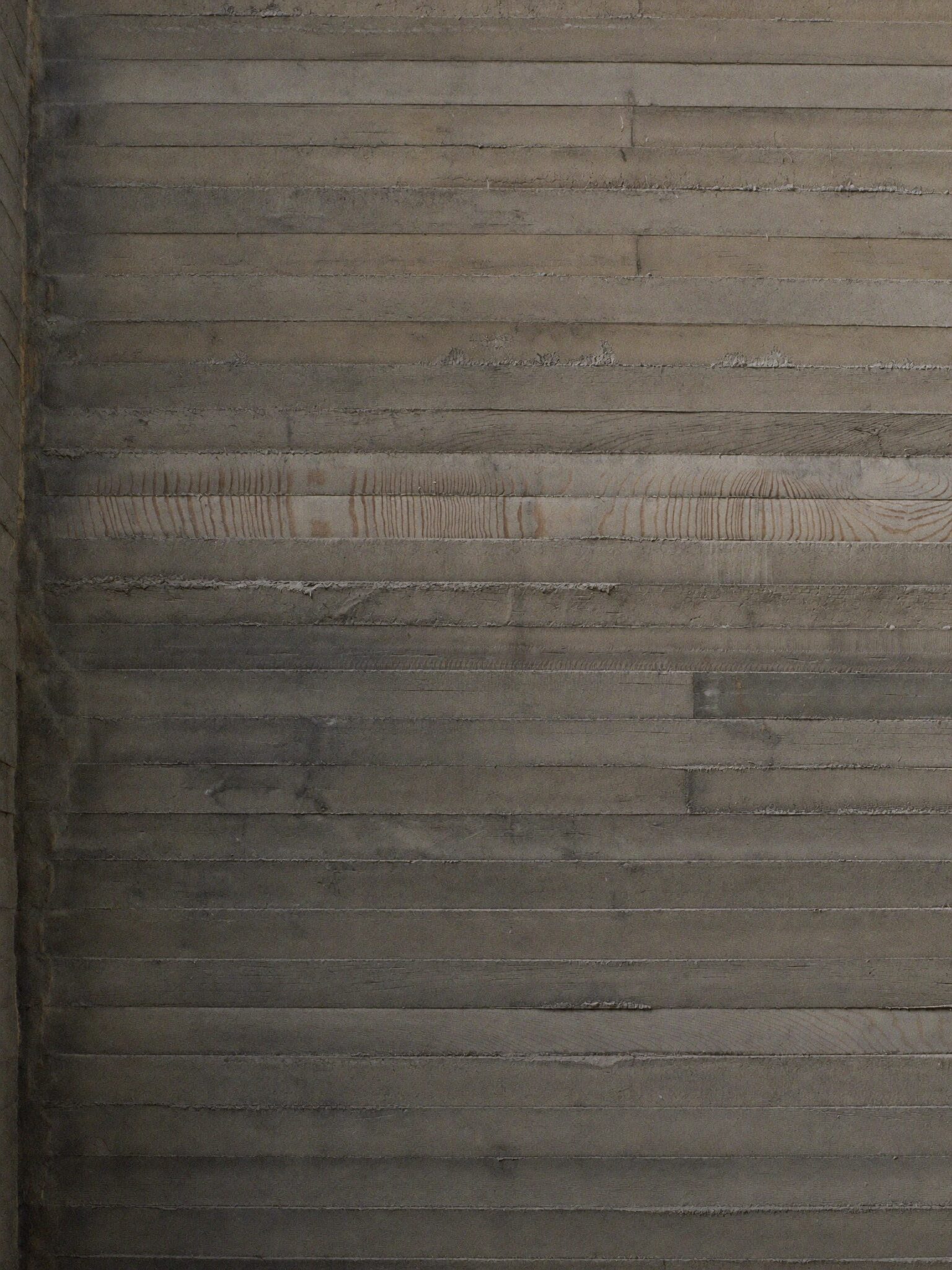 Board-formed concrete texture in raking light