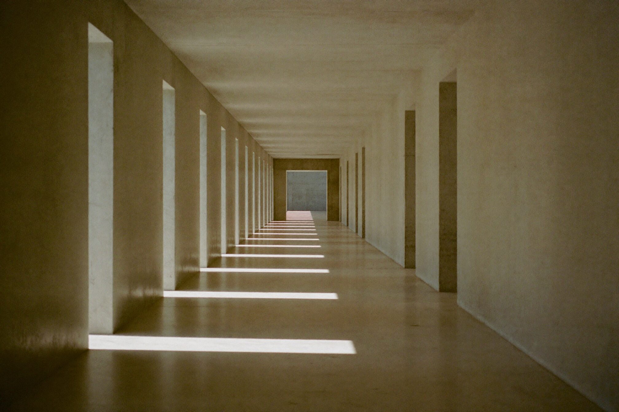 Concrete corridor with rhythmic bands of daylight