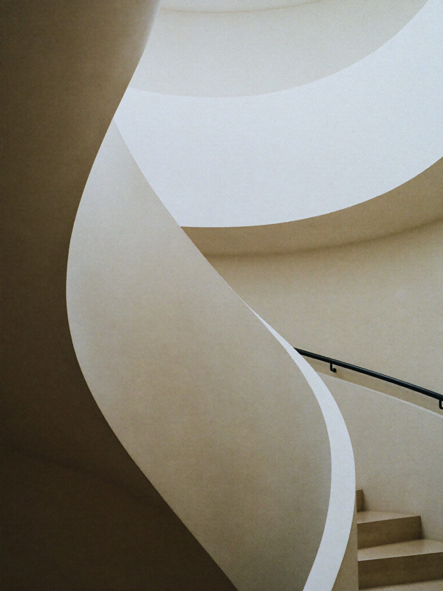 Sculptural pale concrete spiral stair