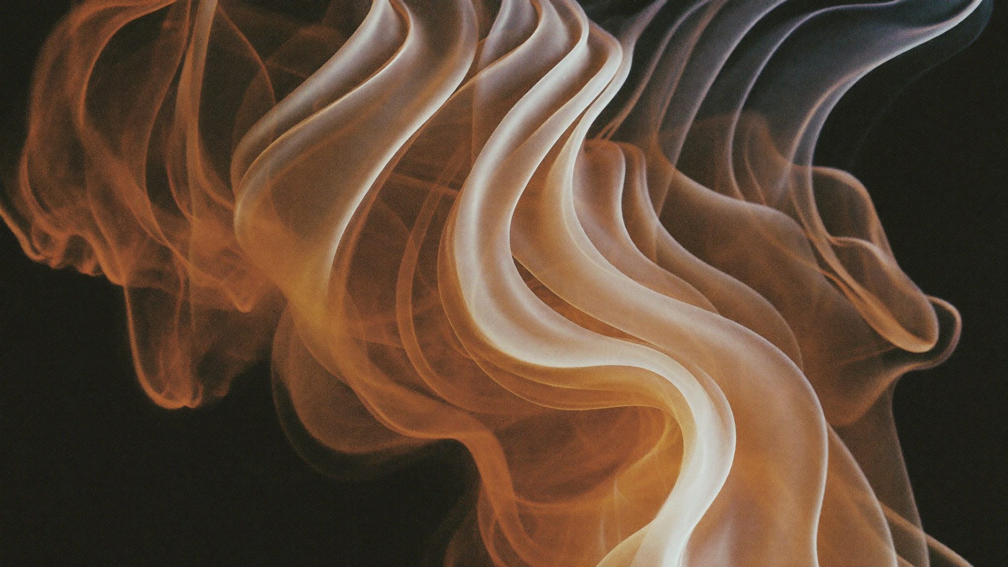 Silk-like ribbons of smoke and amber light