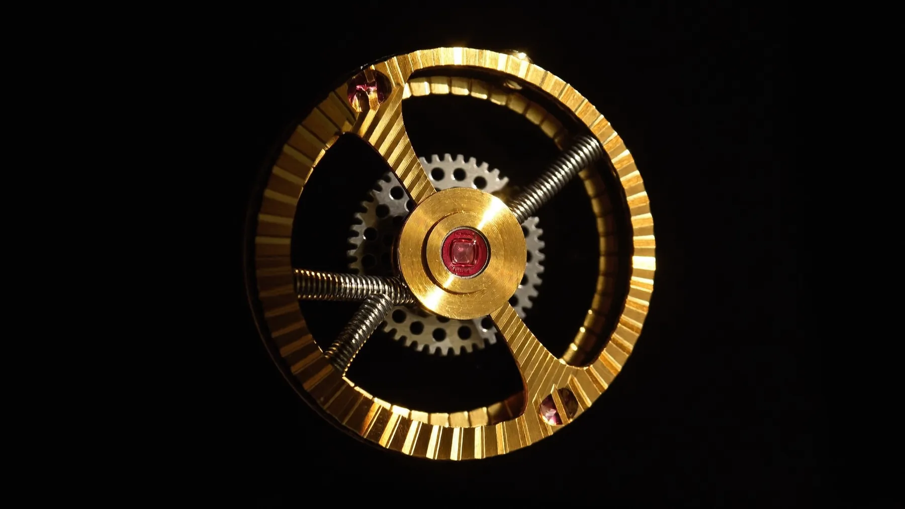 Macro of the M·72 balance wheel on black