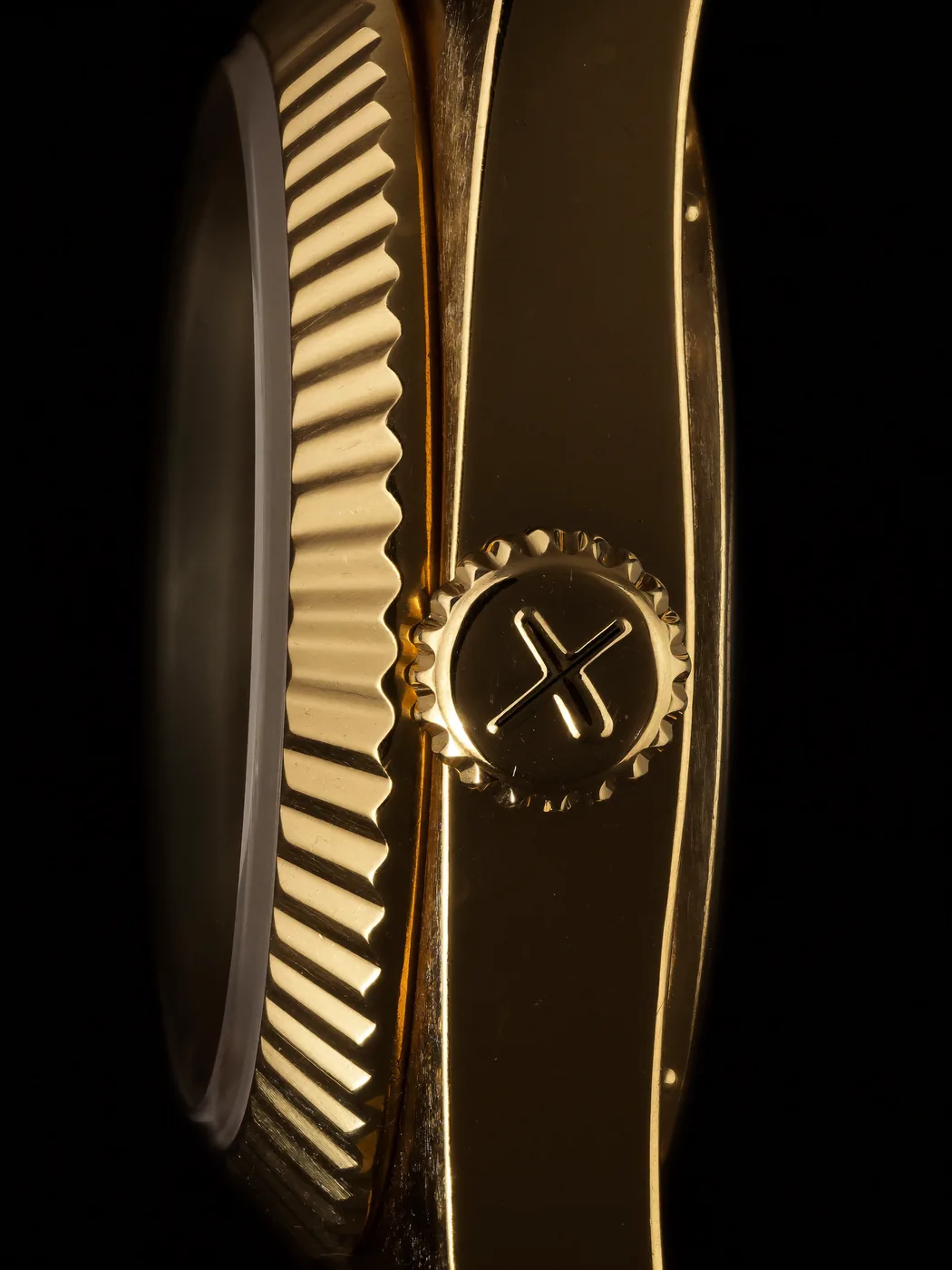 Macro of the fluted gold crown and case flank
